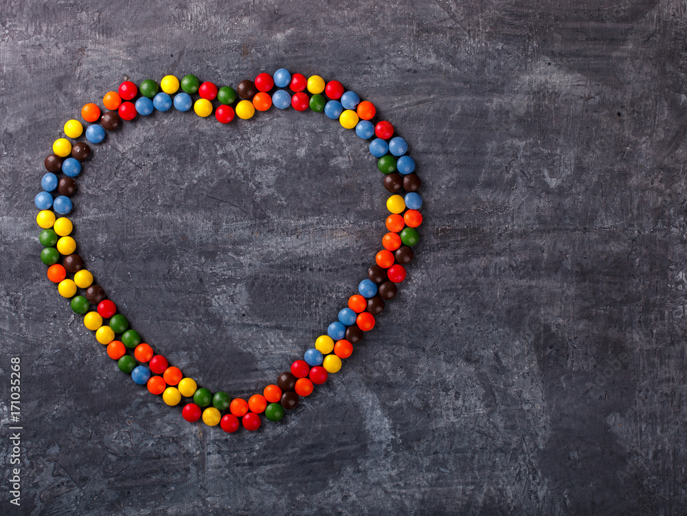 Background of Bright Colored Candy in the shape of a Heart.Holiday Valentine's Day.Holiday Valentine's Day.top view. Copy space. selective focus. Background of Bright Colored Candy in the shape of a Heart.Holiday Valentine's Day.Holiday Valentine's Day.top view. Copy space. selective focus.