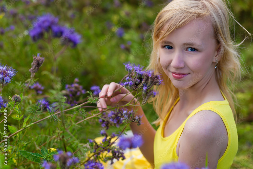Girl in purple flowers outdoors in summer Girl in purple flowers outdoors in summer