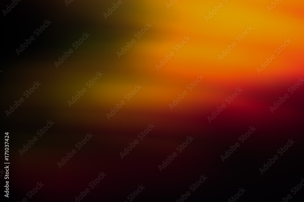 Abstract background of blurred orange, green and red light blur. Bokeh of defocused lines in motion, aurora skylights wallpaper, magic of nature around Abstract background of blurred orange, green and red light blur. Bokeh of defocused lines in motion, aurora skylights wallpaper, magic of nature around
