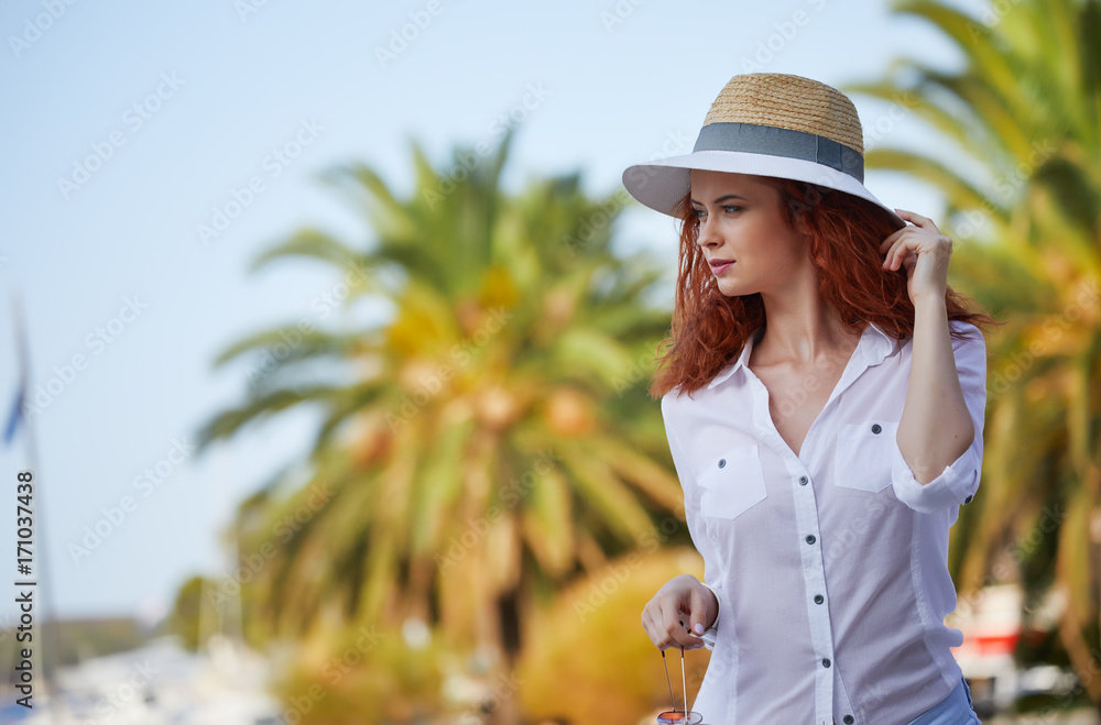Young woman walks on the historical european streets of old town. Beautiful girl travel Europe. Tourist examines the architecture sights of the city.