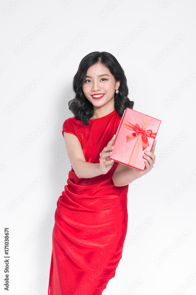Pretty young glamorous asian woman dressed in red dress with a present Pretty young glamorous asian woman dressed in red dress with a present