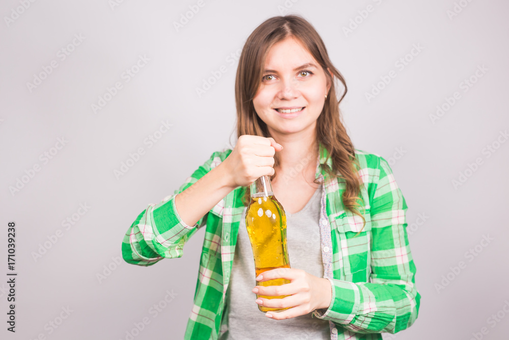 Attractive young woman holding a bottle of beer Attractive young woman holding a bottle of beer