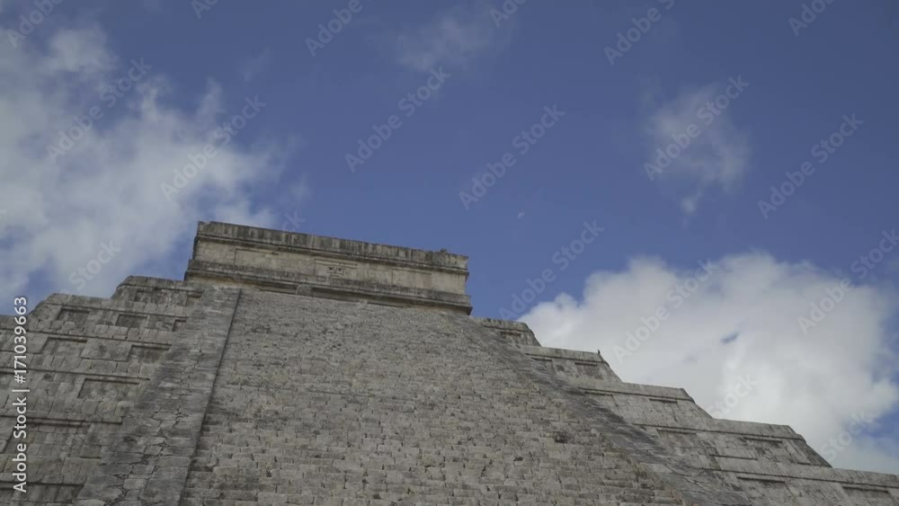 CHICHEN ITZA, MEXICO - MAY 25, 2017: Top of Maya pyramid temple Kukulkan in peninsula Yucatan at sunny summer day CHICHEN ITZA, MEXICO - MAY 25, 2017: Top of Maya pyramid temple Kukulkan in peninsula Yucatan at sunny summer day