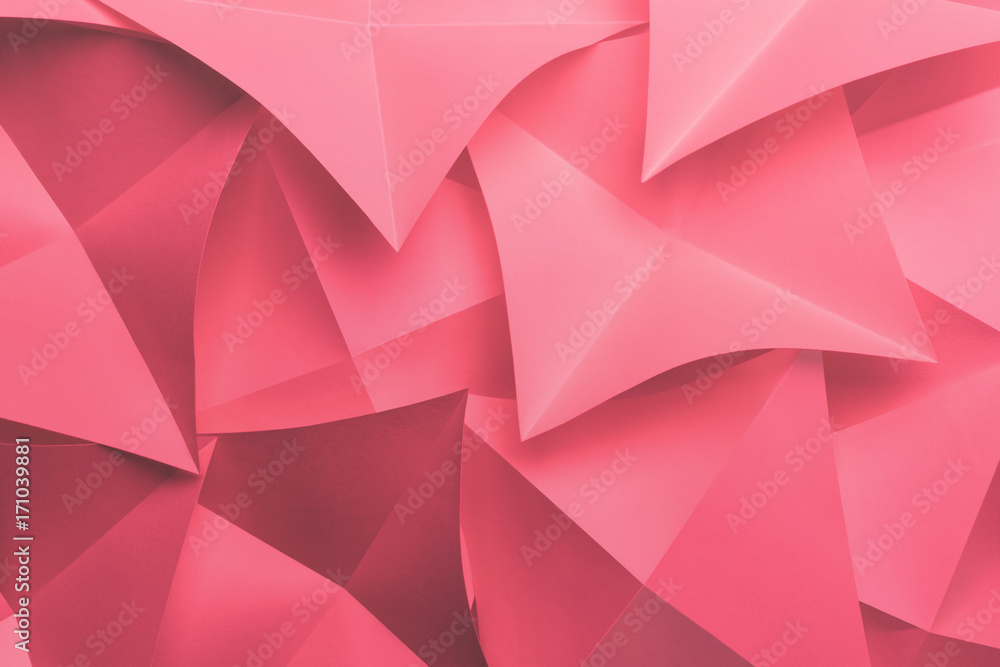 Pink cards folded in pyramidal shapes, abstract background