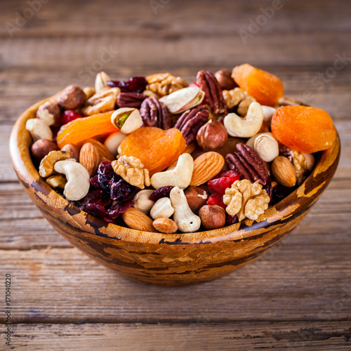 Nuts and dried fruit mix. Concept of Healthy Food. Vintage wooden background. Copy space for Text. selective focus