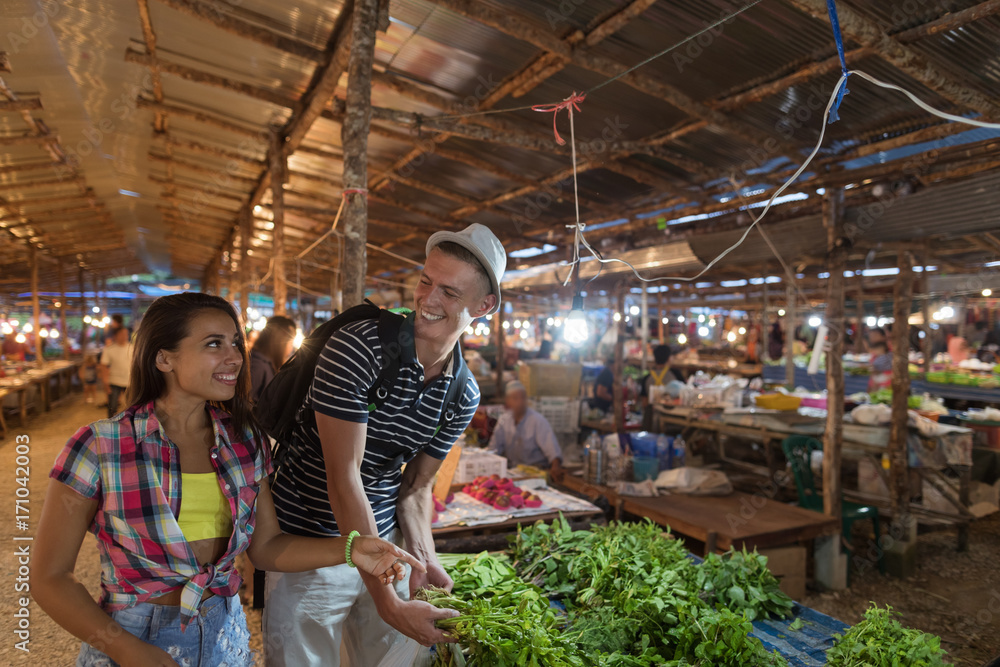 Young Couple Choose Herbs On Vegetables Market Happy Smiling Man And Woman Shopping Together On Traditional Street Bazaar