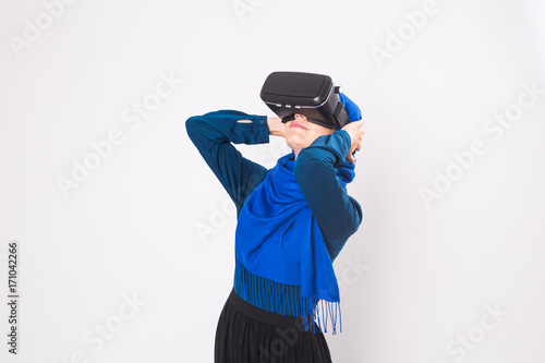 Young muslim woman with virtual reality glasses. Technology, vr, future and people concept