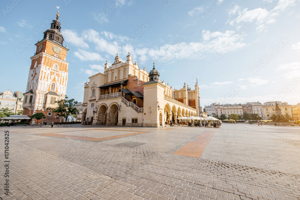 Cityscape view on the Market square with Cloth Hall building and town hall tower during the morning light in Krakow, Poland