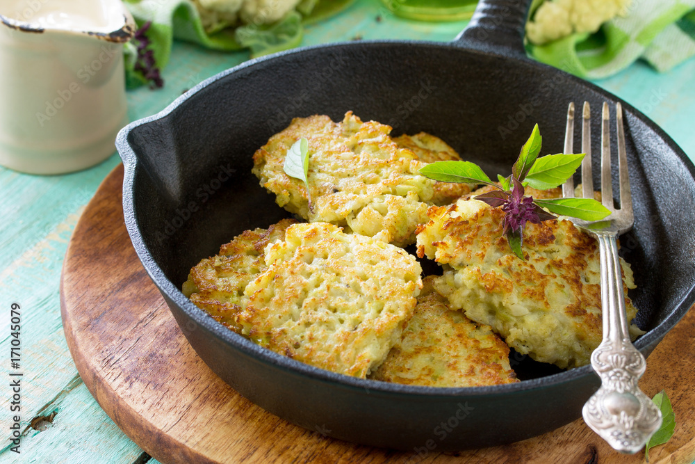 Vegetable pancakes. Fried vegetarian cutlets or fritters on a kitchen wooden table. The concept of healthy and dietary nutrition. Vegetable pancakes. Fried vegetarian cutlets or fritters on a kitchen wooden table. The concept of healthy and dietary nutrition.