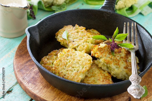 Vegetable pancakes. Fried vegetarian cutlets or fritters on a kitchen wooden table. The concept of healthy and dietary nutrition.