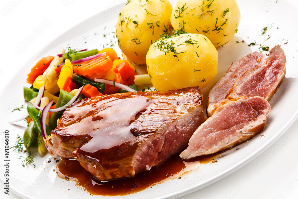Grilled steak with vegetables on white background Grilled steak with vegetables on white background