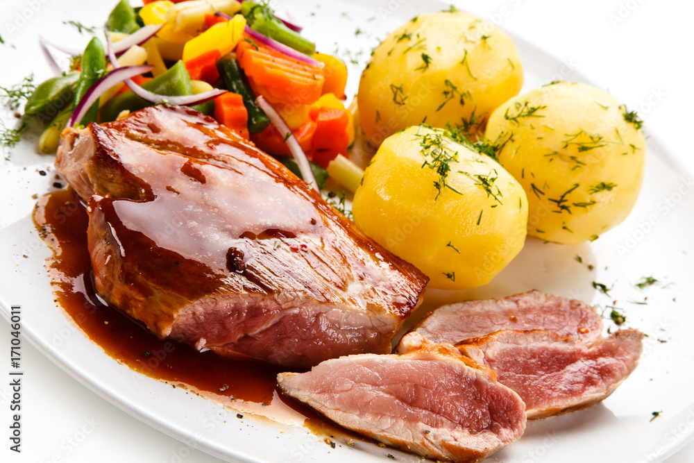 Grilled steak with vegetables on white background Grilled steak with vegetables on white background