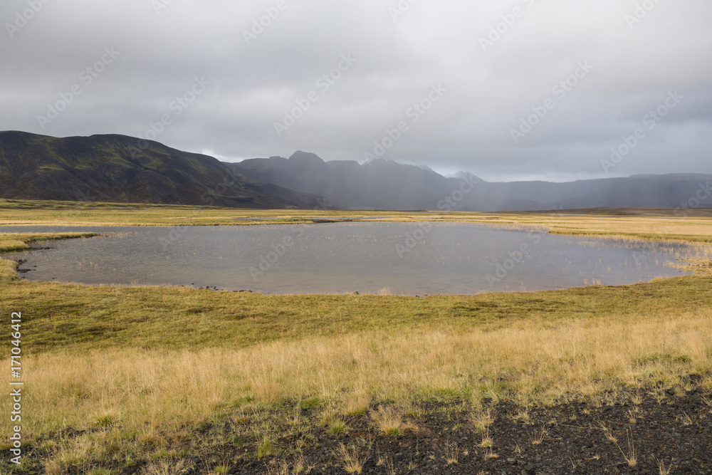 Landscape in Iceland with a pond in the foreground during the autumn