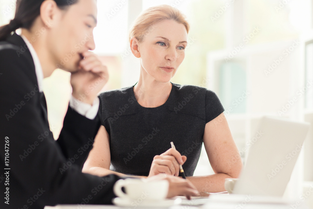 Two confident traders analyzing online stock market data Two confident traders analyzing online stock market data