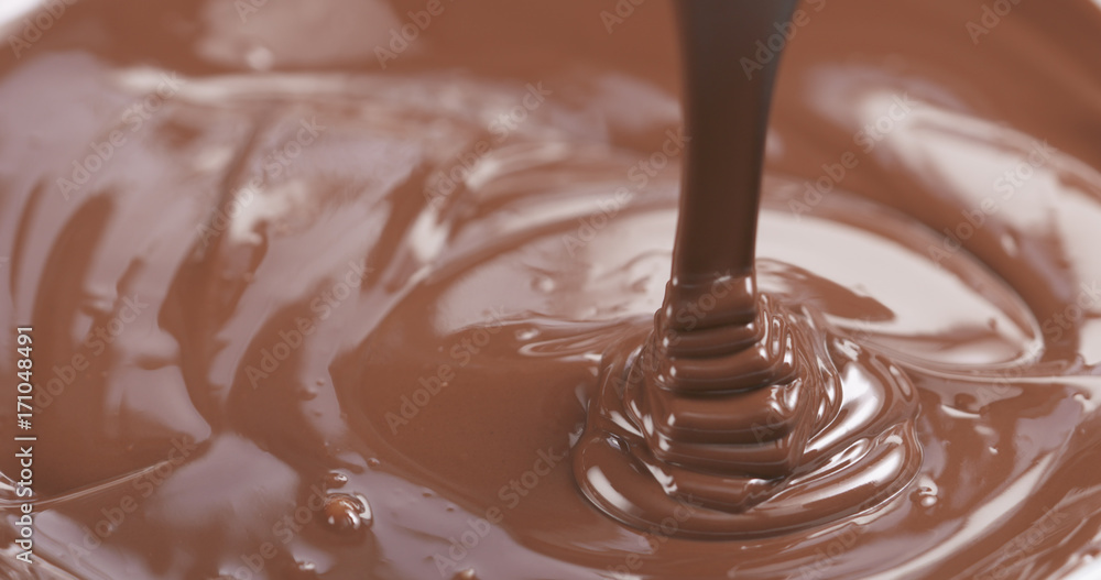 pour milk chocolate from spoon pour milk chocolate from spoon