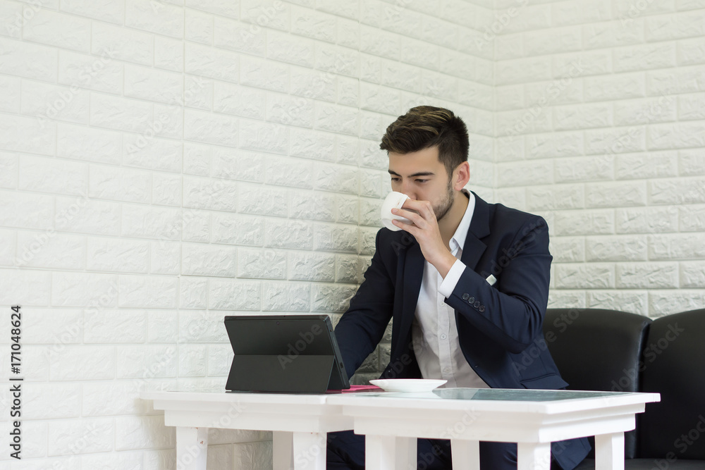 Young businessman have coffee while take a break working at office. Young businessman have coffee while take a break working at office.