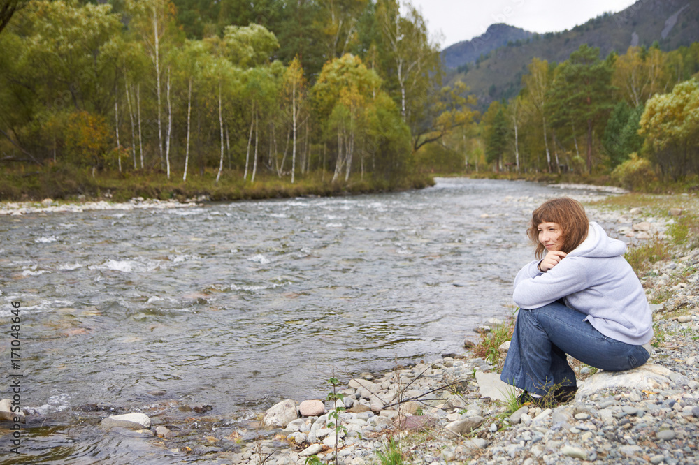 Smiling woman around Altai mountain river. Autumn Smiling woman around Altai mountain river. Autumn