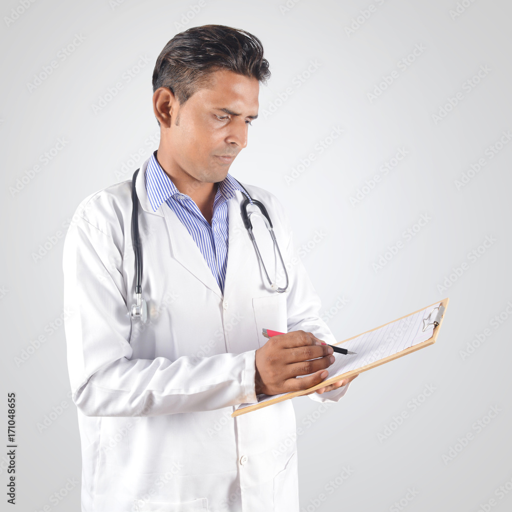 Male doctor with stethoscope holding clipboard isolated professionally Male doctor with stethoscope holding clipboard isolated professionally