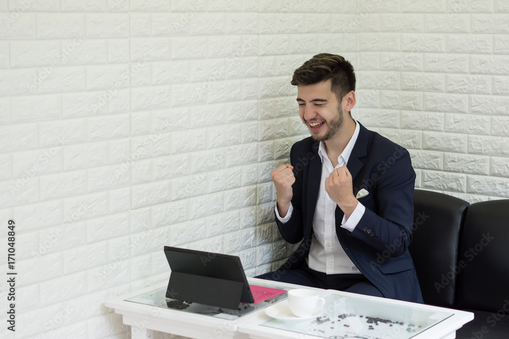 Successful Young businessman working on laptop at office. Successful Young businessman working on laptop at office.