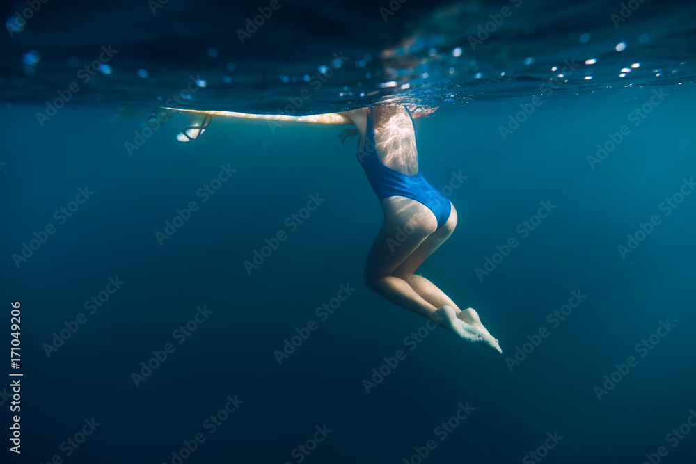 Underwater woman with blue bikini in ocean