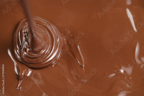 pouring melted premium dark chocolate from above