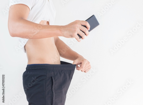 Canvas-taulu Young man looking with holding cell phone for selfie him crotch, Healthy concept