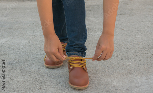 young woman tying shoe safety.