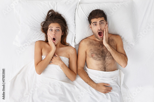 Fotografie Frightened couple watch horror films together before sleep