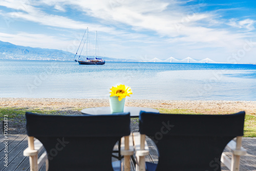 Принти на полотні Two chairs in street outdoor cafe on Embankment of Corinth Gulf