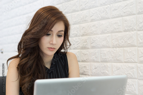 Close up of Young business woman working on her laptop at office.