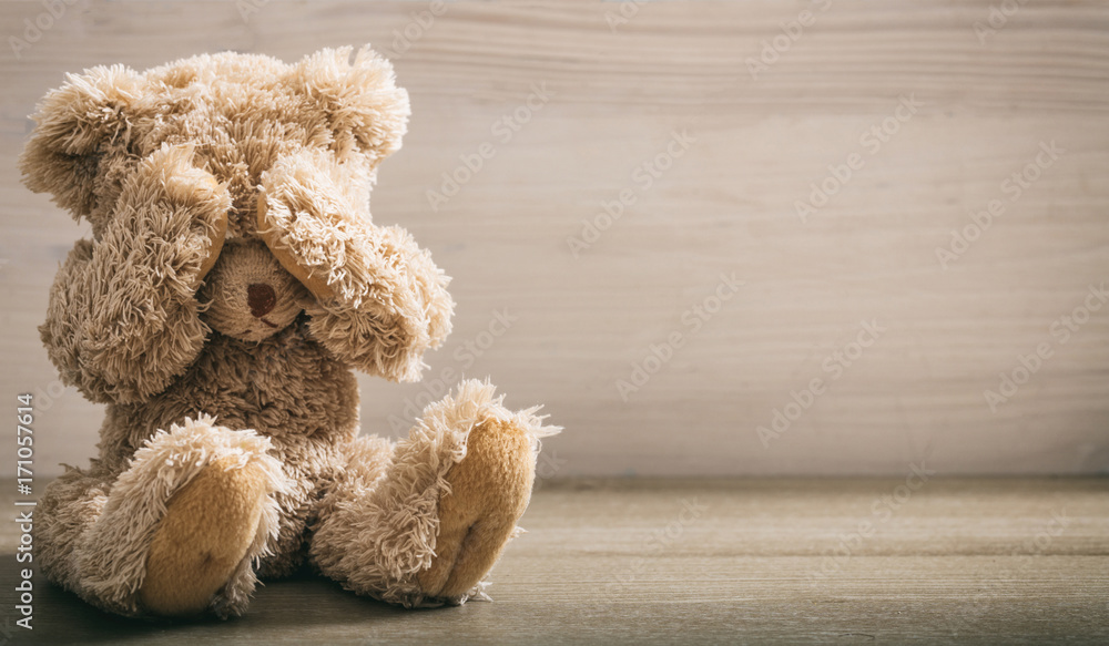 Child abuse concept. Teddy bear covering eyes Stock Photo