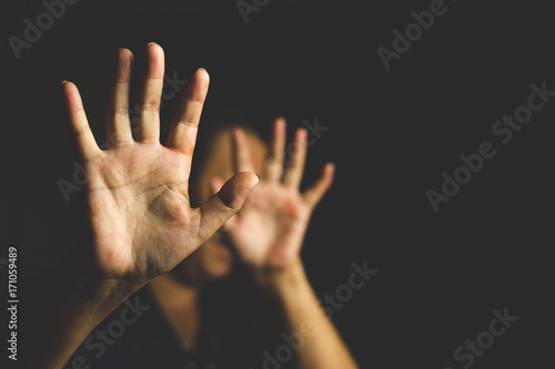 Woman with her hand extended signaling to stop (only her hand is in focus)