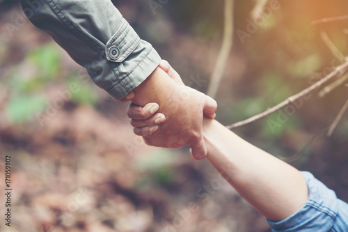Friends holding hands pulled Help. Help each other or Strong hold.