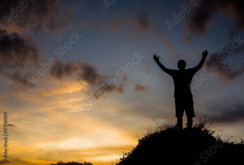 silhouette man on hill with sky for background