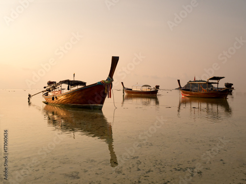 Local long tail boat in sea at sunrise when tide is falling or going out. Peaceful feeling at Lipe Island  Satun  Thailand.