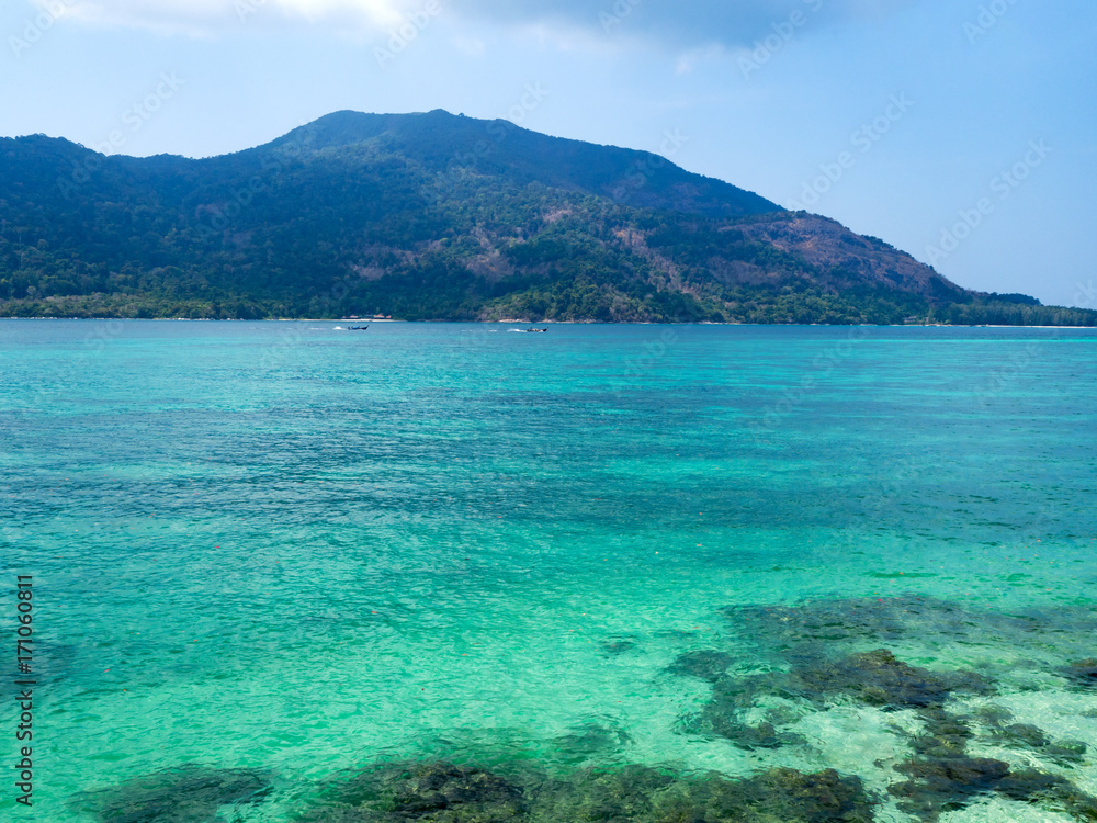 Crystal turquoise green sea ocean clear water and mountain at Lipe Island, Satun, Thailand. Crystal turquoise green sea ocean clear water and mountain at Lipe Island, Satun, Thailand.