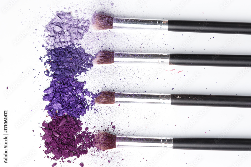 Fototapeta premium Crushed eyeshadows and make-up brushes
