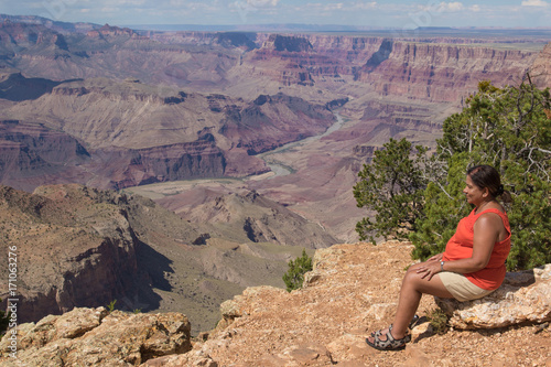 Woman sitting on the rim of the Grand Canyon © peterralph