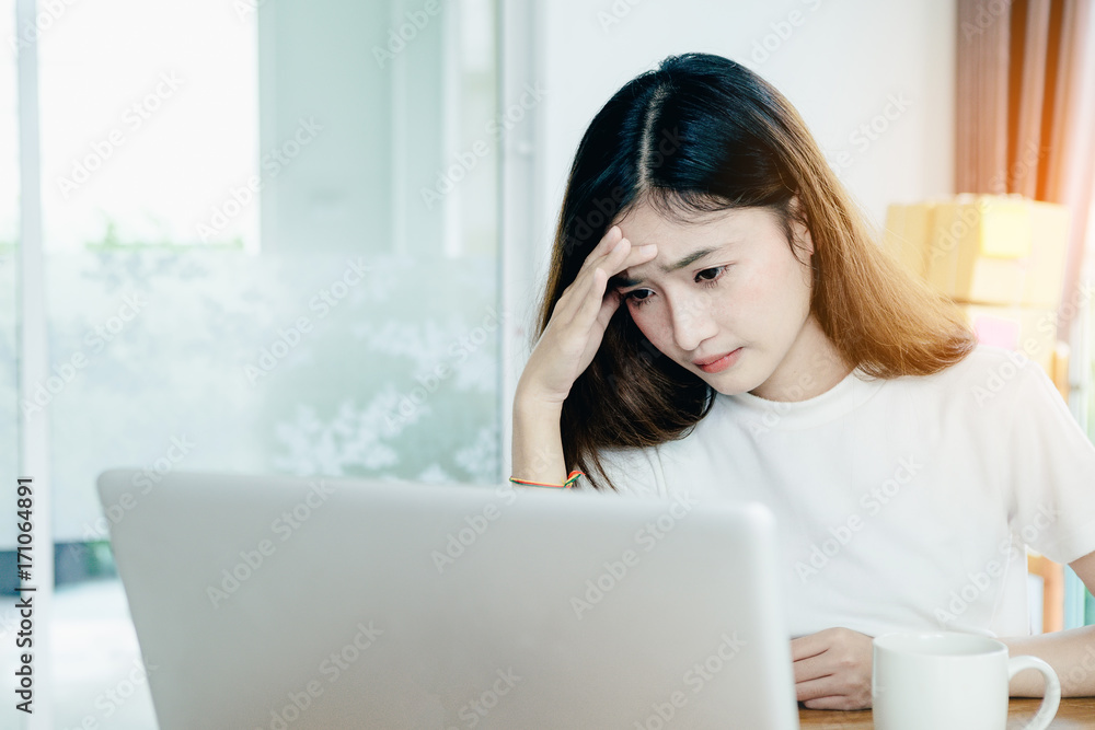 Young asian girl is freelancer with her private business at home office, working with laptop, coffee, online marketing, Customer order and packaging or packing. Young asian girl is freelancer with her private business at home office, working with laptop, coffee, online marketing, Customer order and packaging or packing.