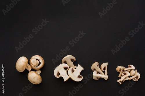 Stages of cutting mushrooms on black background
