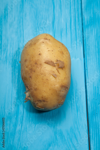 Potatoes on a blue wooden background
