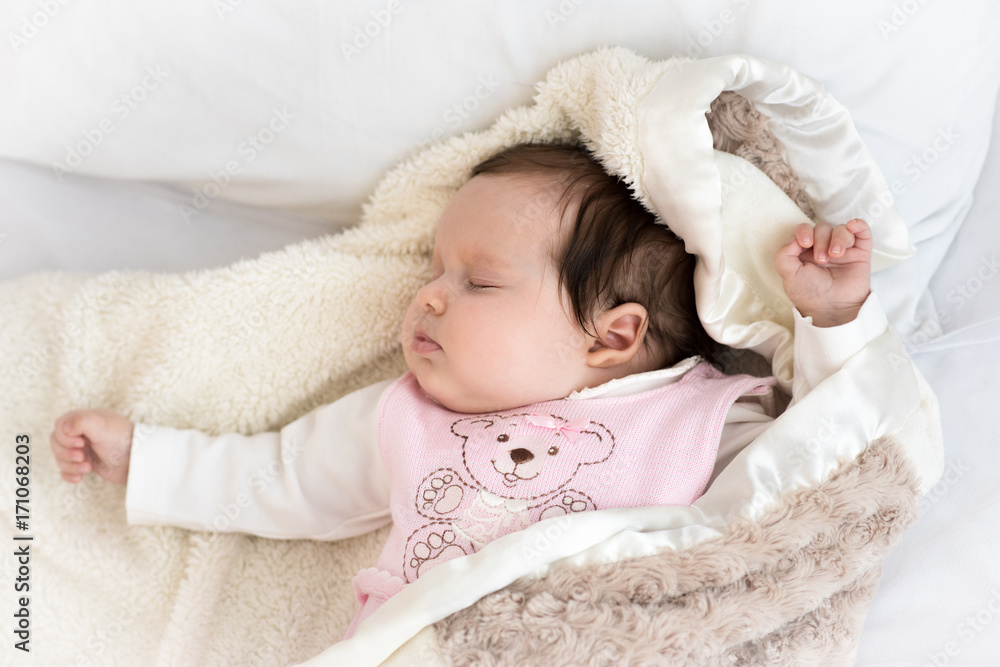 Baby girl sleeping on white fur blanket Baby girl sleeping on white fur blanket