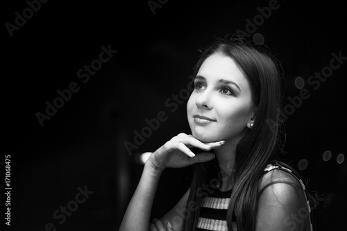 Girl looking on a moon at night, city view, black and white photo