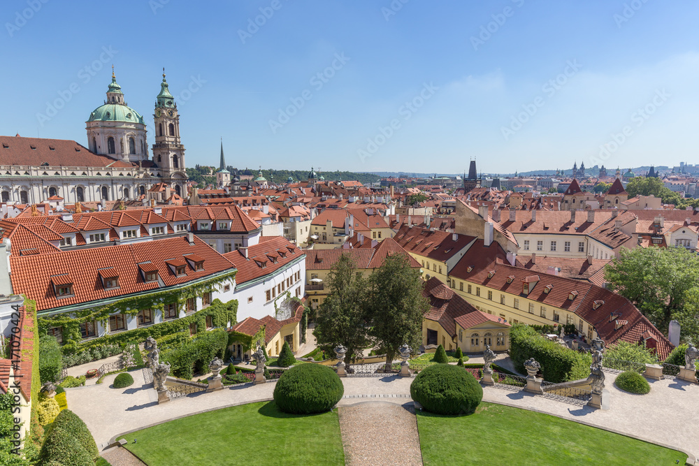 Obraz premium View of the Vrtba Garden (Vrtbovská zahrada), St. Nicholas Church and other old buildings at the Mala Strana District (Lesser Town) in Prague, Czech Republic on a sunny day.