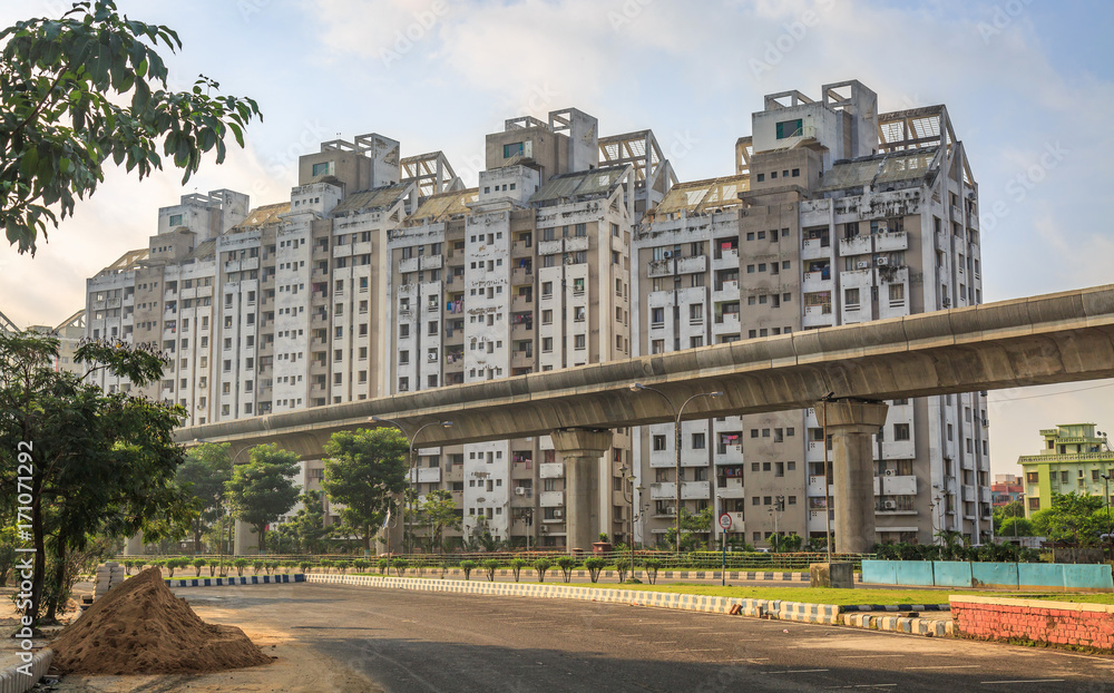 High rise city residential buildings with under construction over bridge at Kolkata, India.