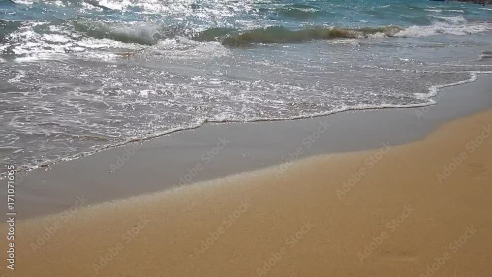Sun reflections, white waves and limpid turquoise sea on a sandy golden beach in Greece. Sun reflections, white waves and limpid turquoise sea on a sandy golden beach in Greece.
