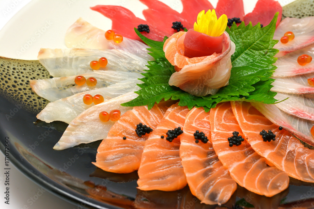 Close-up Japanese food raw fish mixed sashimi in plate Japanese style (maguro, otoro, salmon, sea bass, hamachi) on white background Close-up Japanese food raw fish mixed sashimi in plate Japanese style (maguro, otoro, salmon, sea bass, hamachi) on white background