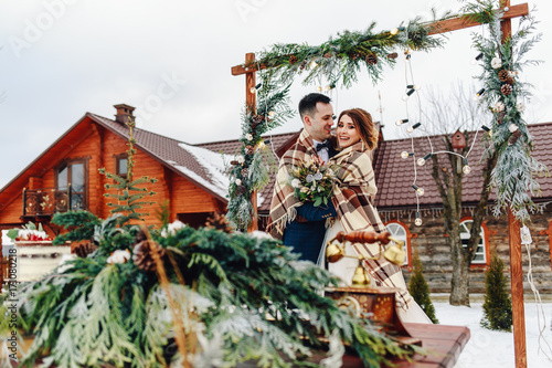 Bride and groom embracing. Outdoors wedding. The concept of a winter wedding © Vladimir