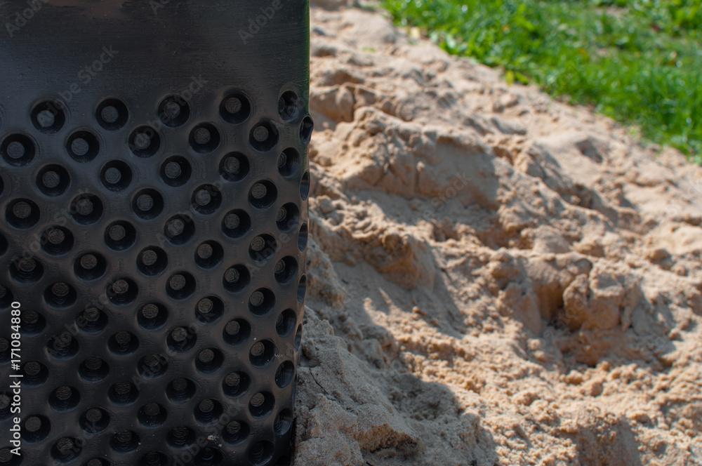 Black bucket foil in the sand Black bucket foil in the sand