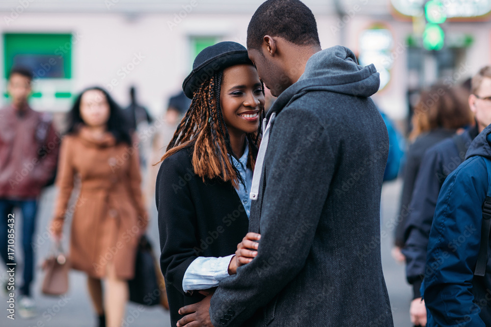 Happy romantic couple on crowd background. Joyful African American. Stylish black people meeting on street, youth relationships, love concept